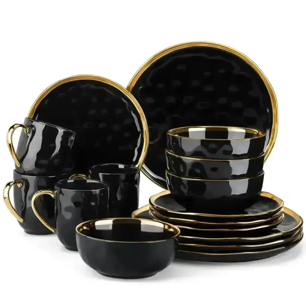 Svart dinnerware set med guldringar för IVORY - Servis - 16 delar